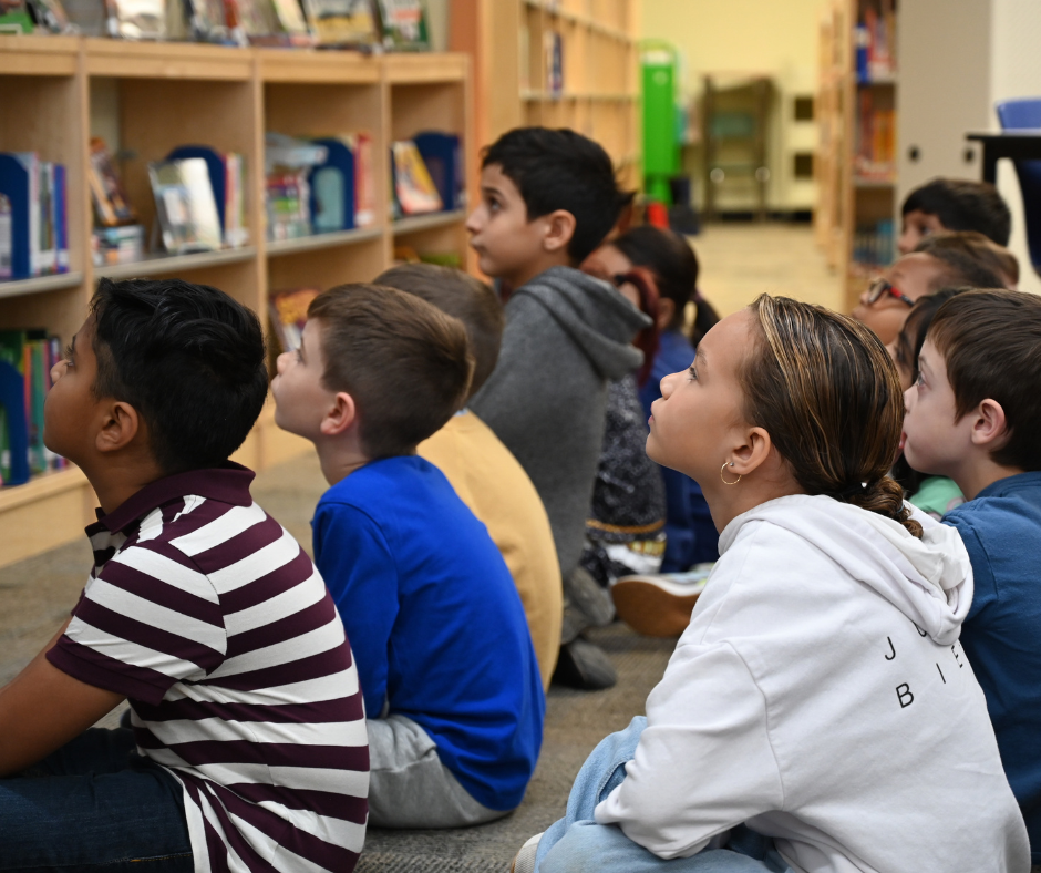 Students listing to Michael Banson Reading Book