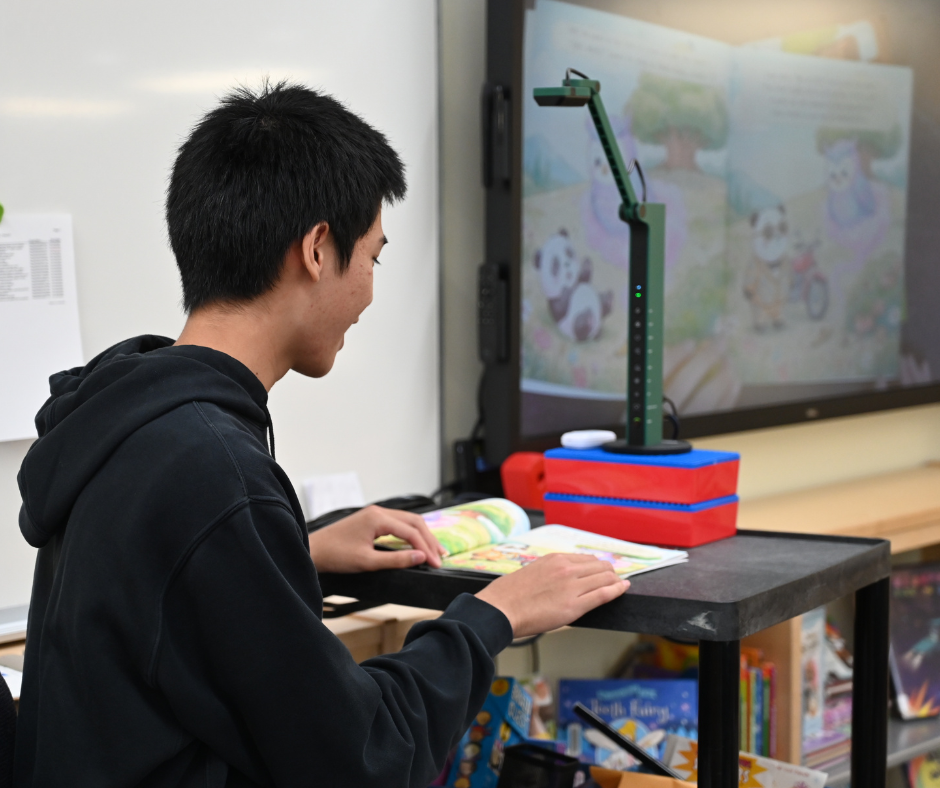 Michael Banson Reading Book to Students
