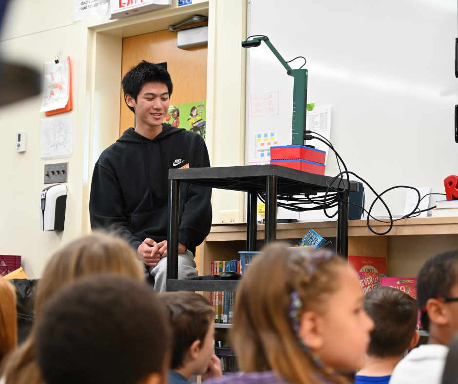 Michael Banson Reading Book to Students