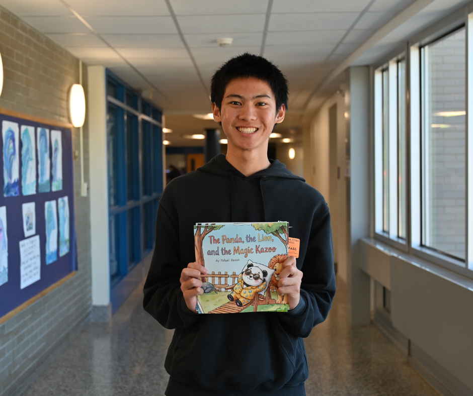 Michael Banson holding up his book