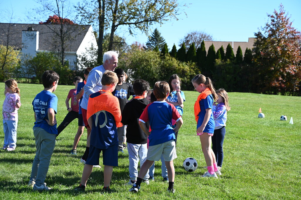 group of students playing soccer