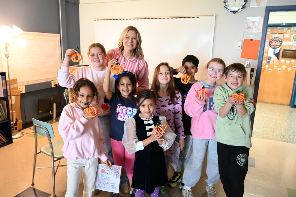 student pumpkin crafts with a group of students showing off their pumpkins