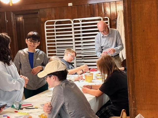group of students doing arts and crafts with a teacher