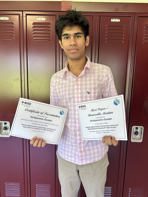 Hridaanshu Gusain poses with certificates from the IEEE System’s Council Conference for Collegiate Students.