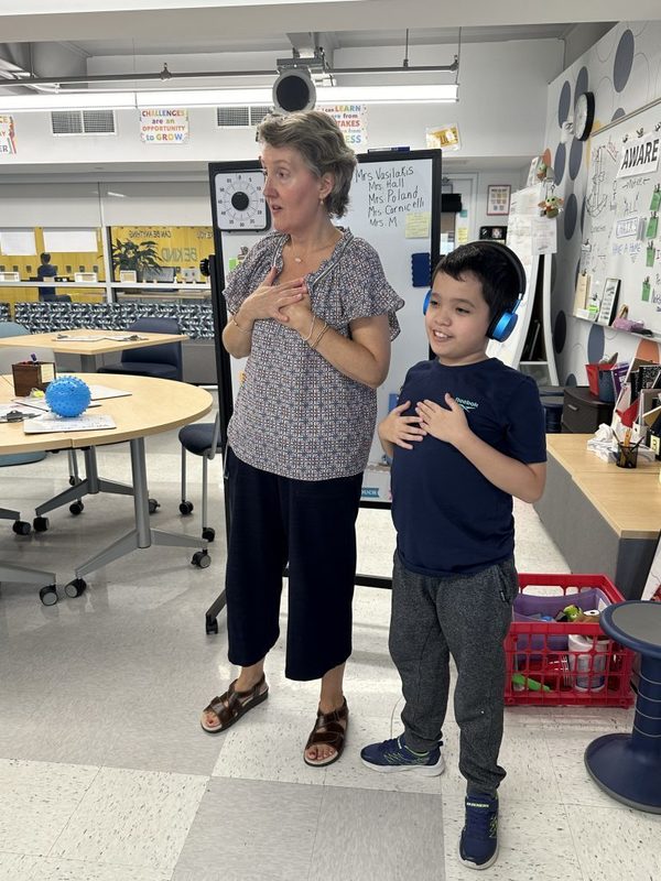 Mrs. Michelle Vasilakis and one of her students lead an exercise during Wellness class.