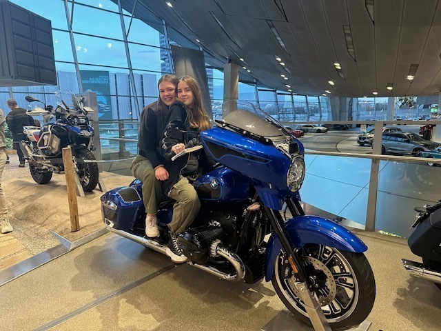 A couple of students took a seat on a motorcycle at BMW World in Munich, Germany.