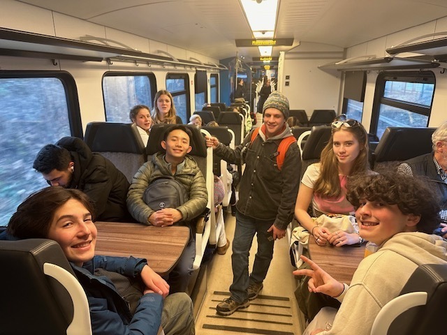 Students ride the train together as they travel around Germany.