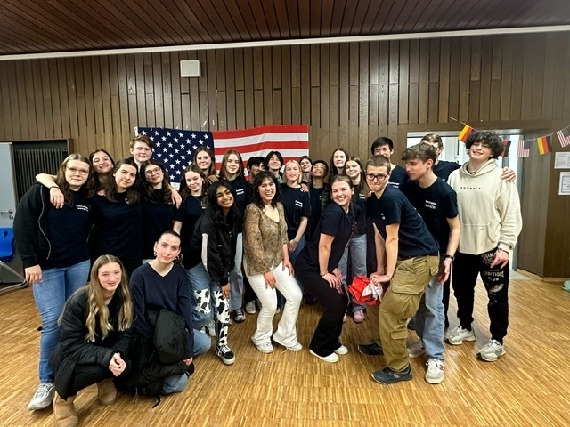 Students pose in front of the American flag during their exchange trip to Germany.
