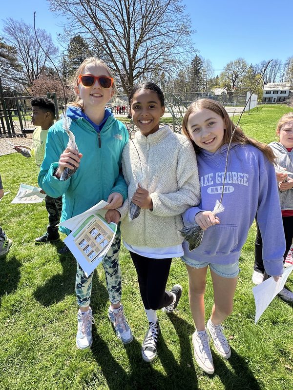 Three Loudonville students show off their saplings to take home.