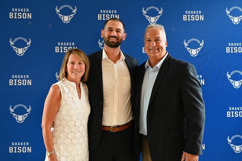 Class of 2024 Shaker Athletic Hall of Fame inductee Chris Landers poses with his parents at the ceremony.
