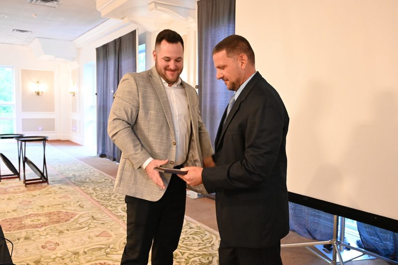 Class of 2024 Shaker Athletic Hall of Fame inductee Schuyler Huntington receives his plaque from football coach Greg Sheeler.