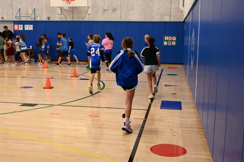 Running club doing a lap around the gym