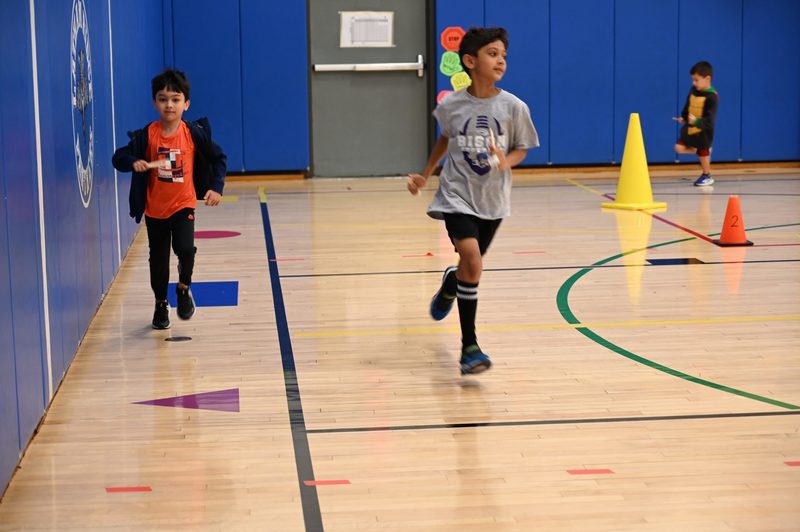 Running club doing a lap around the gym