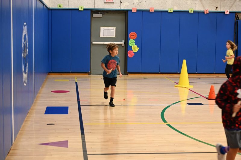 Running club doing a lap around the gym