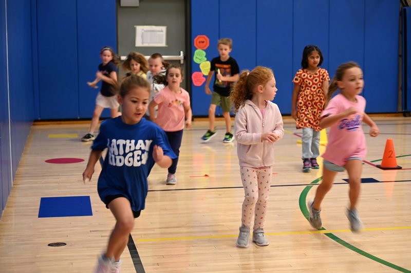 Running club doing a lap around the gym