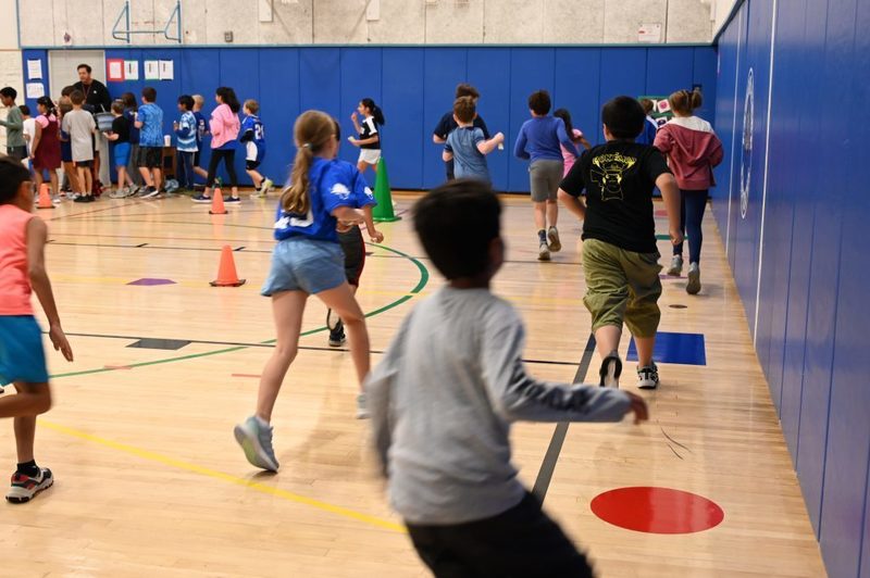 Running club doing a lap around the gym