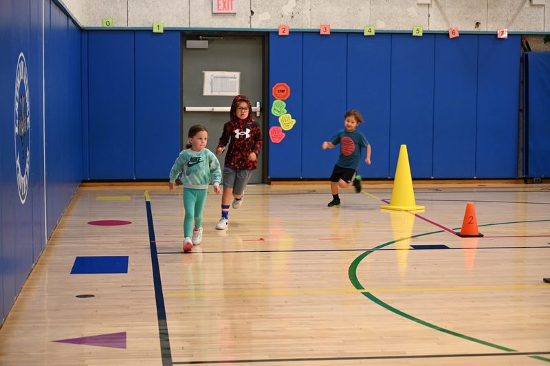 Running club doing a lap around the gym