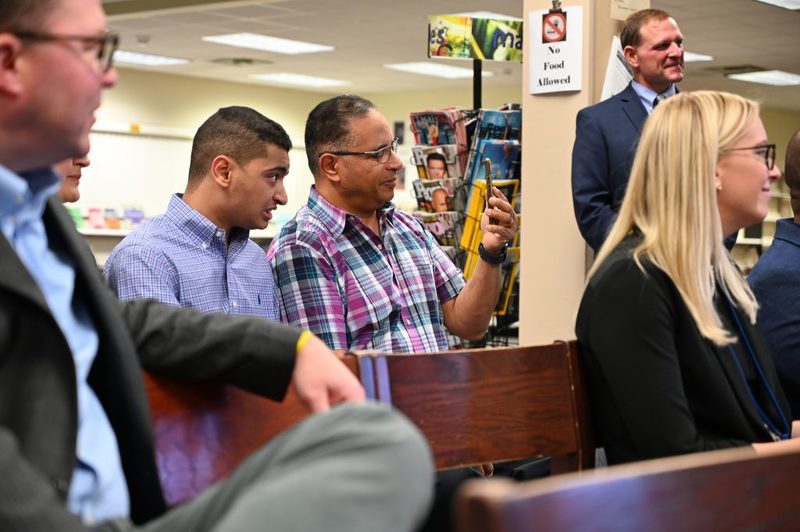 Anthony Sadek and his father look on at his awards presentation at the Board of Education meeting.