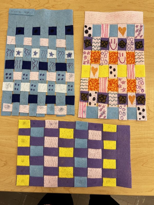 Three kente cloths created by students in a lesson on math transformations.