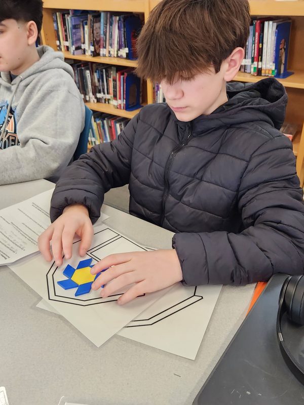Students create barn quilts using balsa blocks.