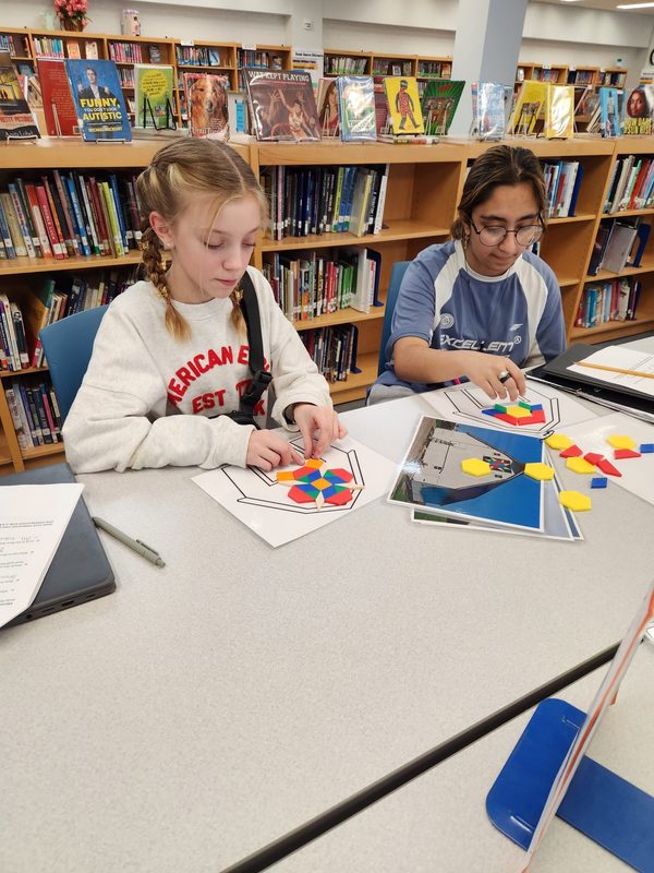 Students use balsa blocks to create barn quilt designs.