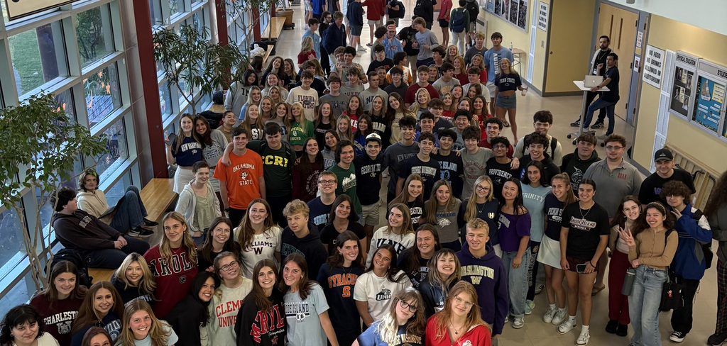 Graduating Students smiling up at a camera