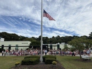 front of FPES with flag at half mast