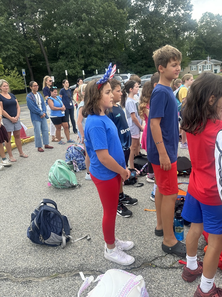 Students stand respectfully in honor of September 11th