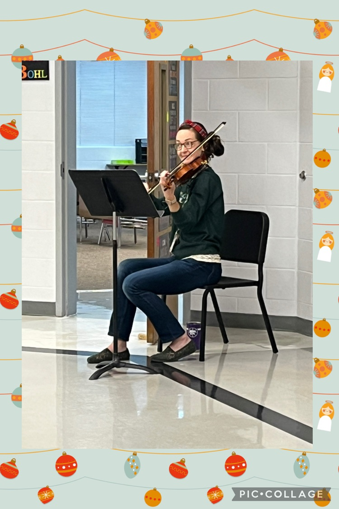 Mrs. Crosson playing the violin to spread holiday spirit