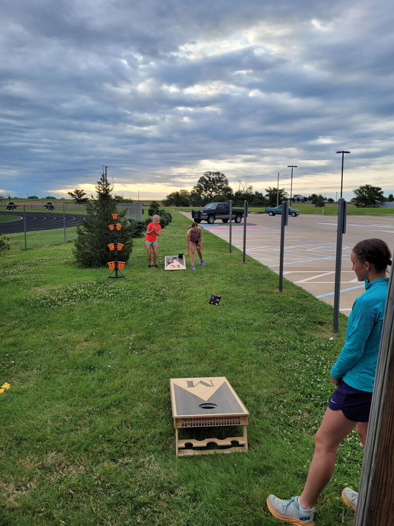 XC runners enjoying a game of cornhole while waiting for their leg in the 50 mile team relay.