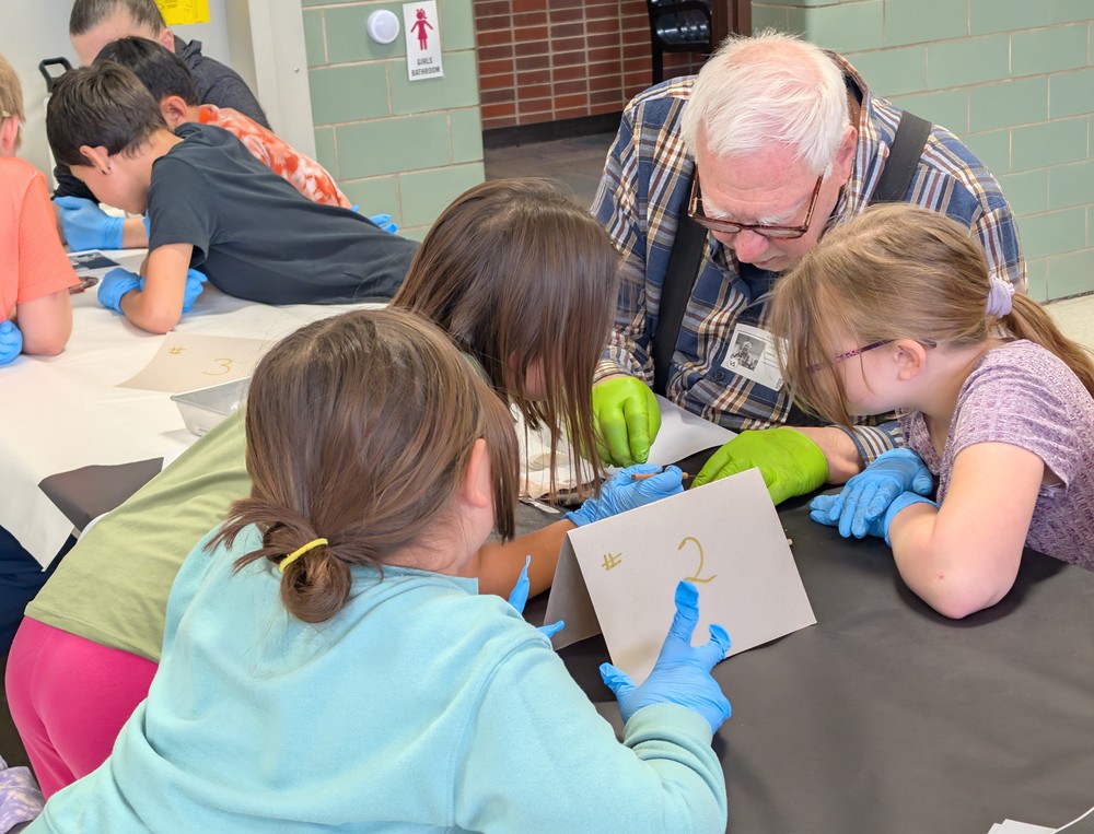 Students and community members looking at fish.