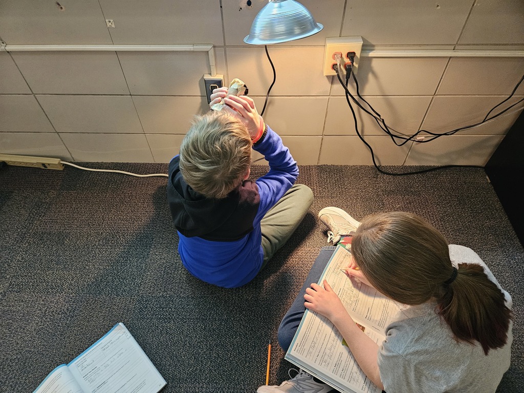 students studying a light source