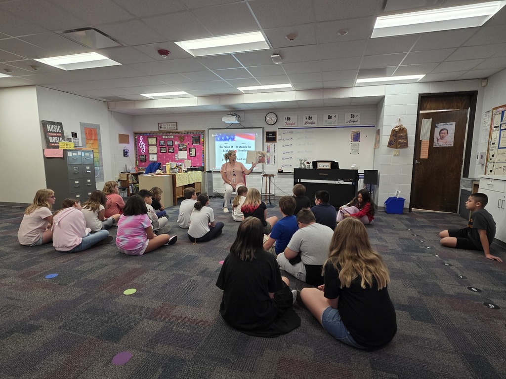 Fifth grade students listening to a book.