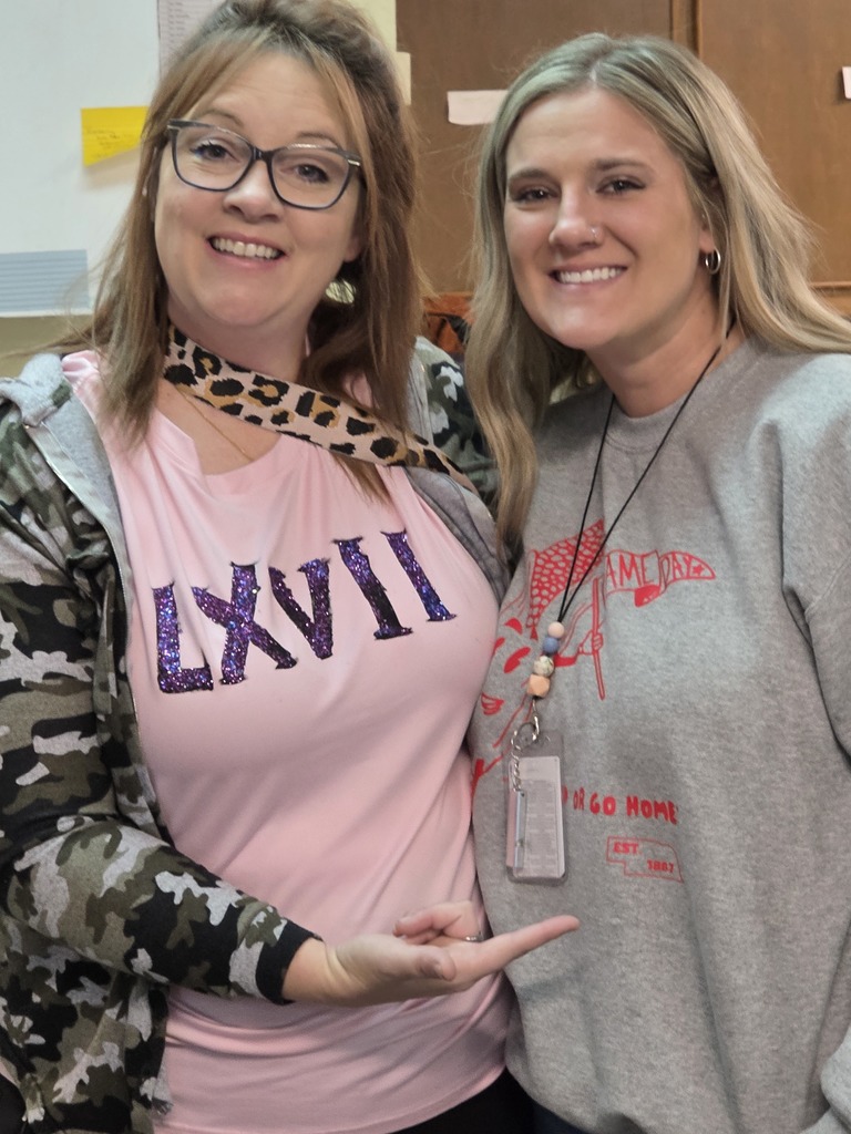 Special education teacher and para showing off their six and seven.