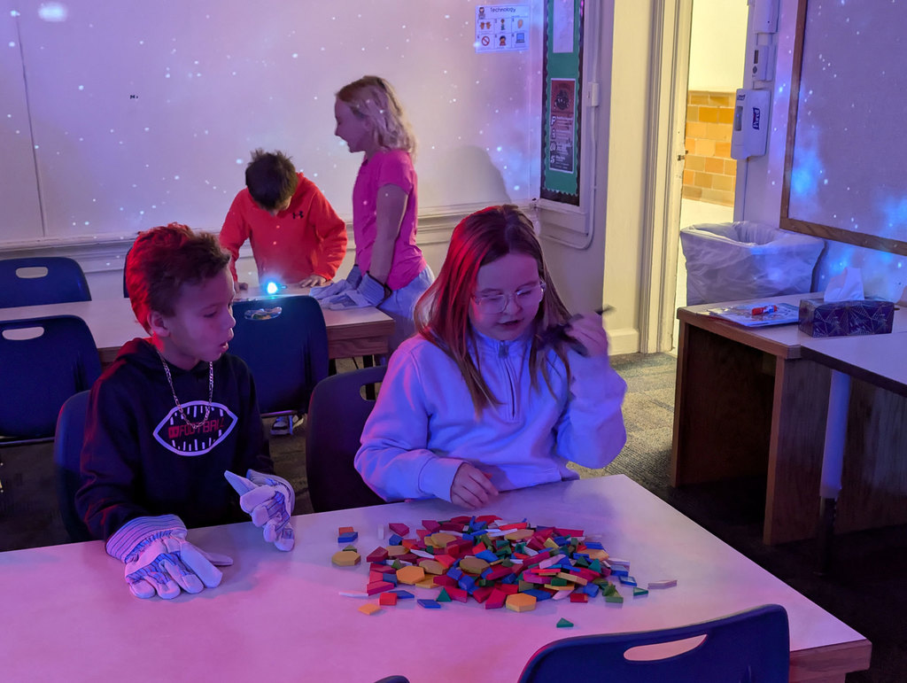 Cody students putting together space puzzle