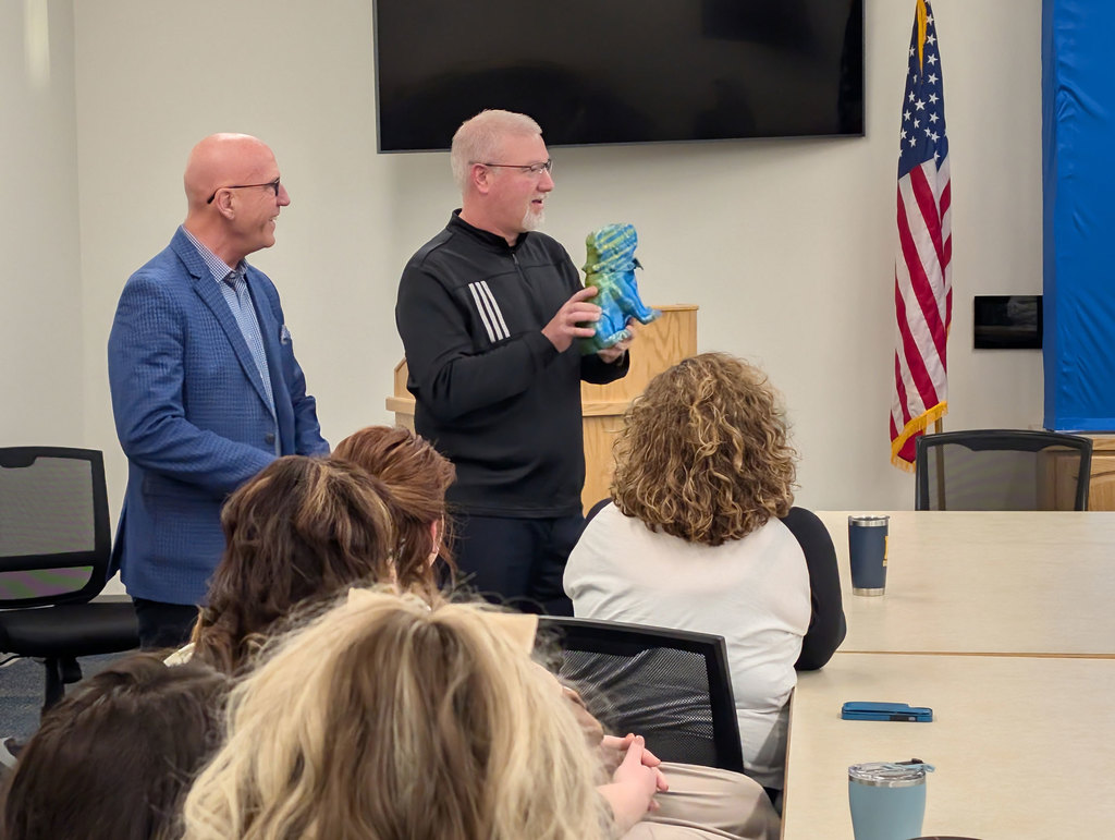 Dr. Rhodes receiving his bulldog statue.