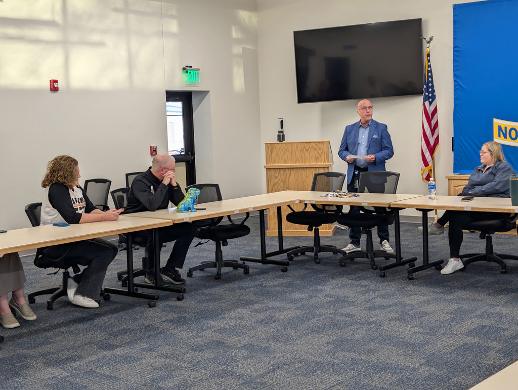 Mr. Mills presenting the Bulldog All Star Award to Dr. Rhodes.