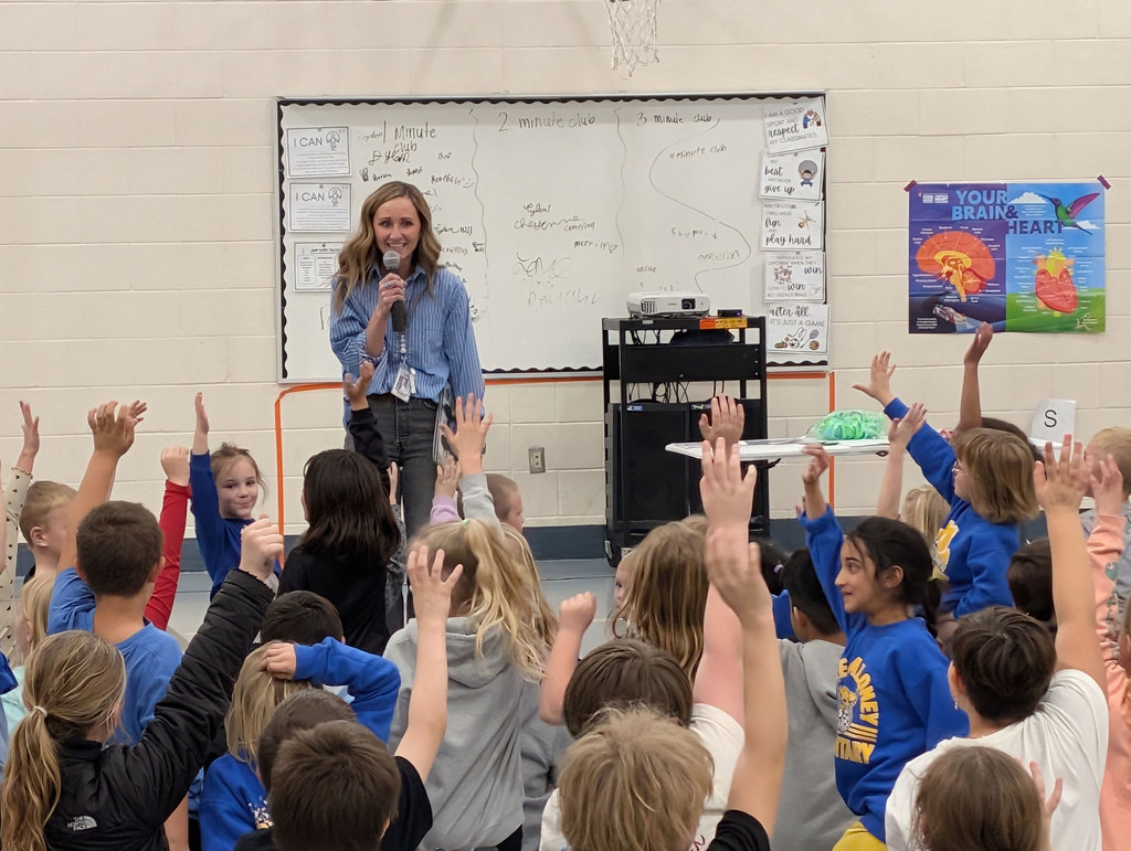 Students volunteering to help at an assembly.
