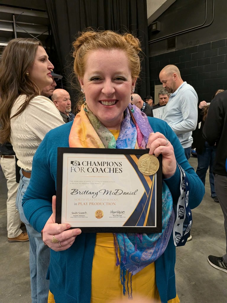 Mrs. McDaniel holding her award!