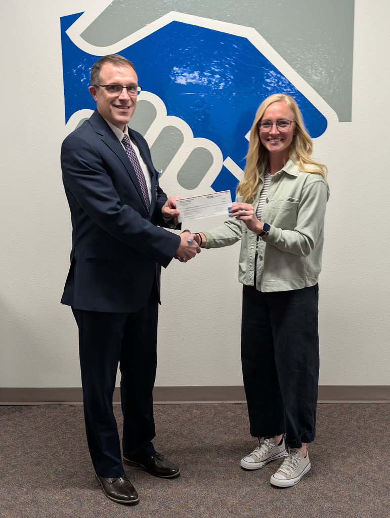 Dr. McDonald receiving a check from Western Nebraska Bank.