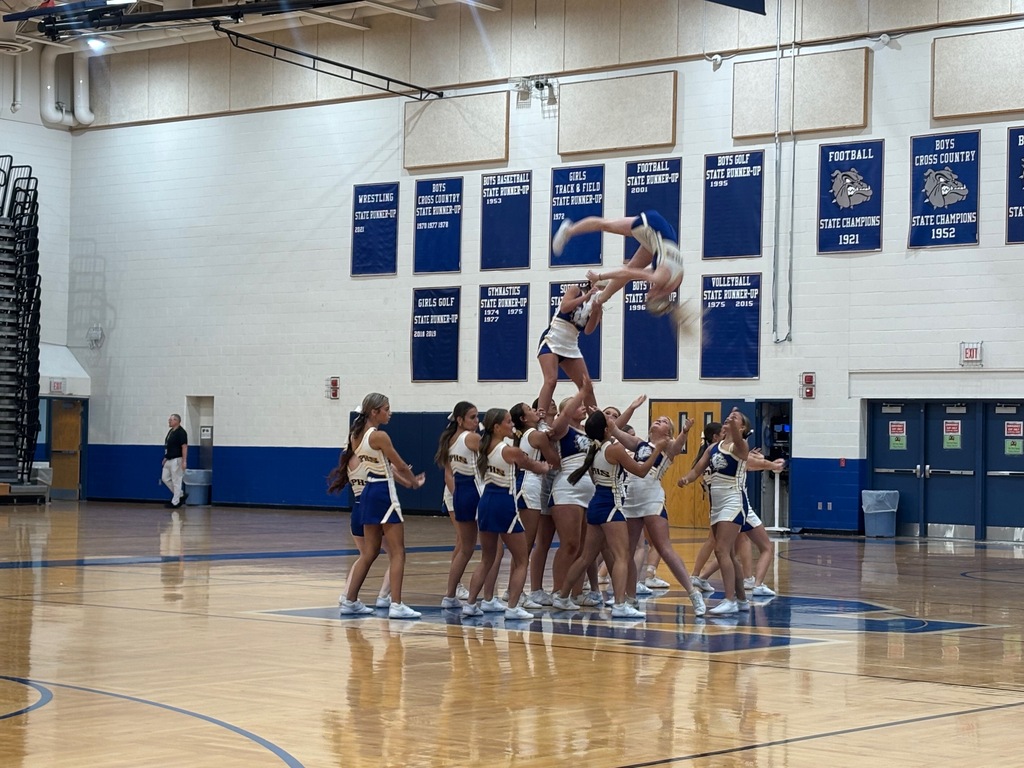 Cheerleaders performing a stunt at pep rally