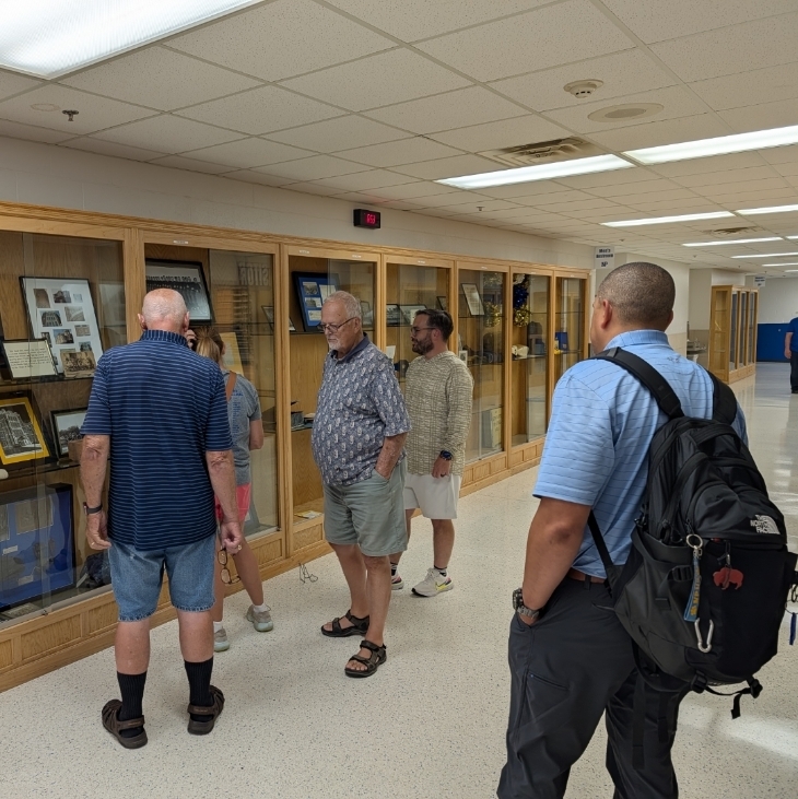 alumni room team helping to put items on display