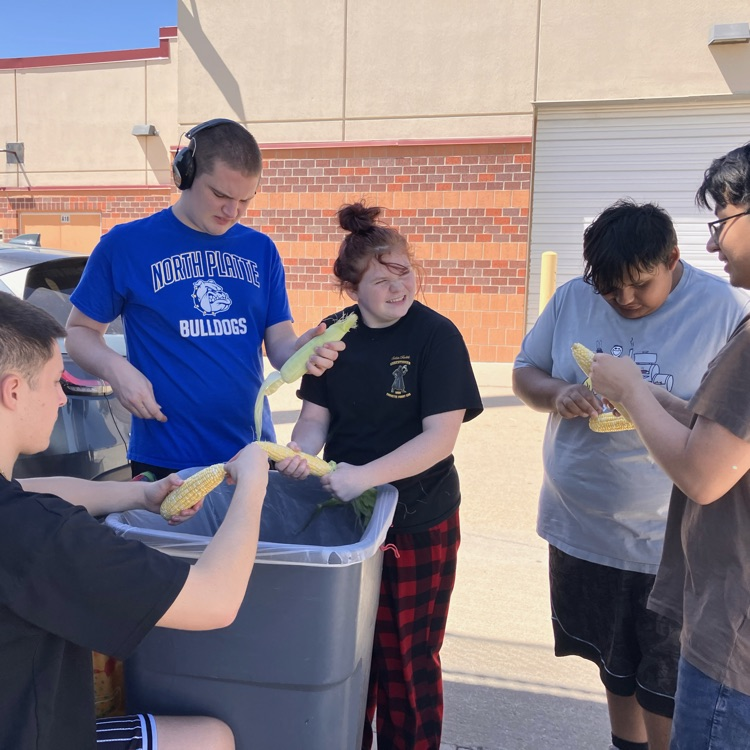 Students prepare corn for cooking unit in Culinary II