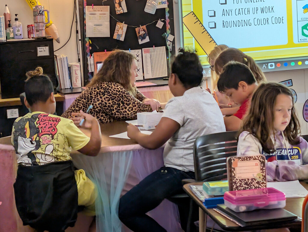 Students working with teacher