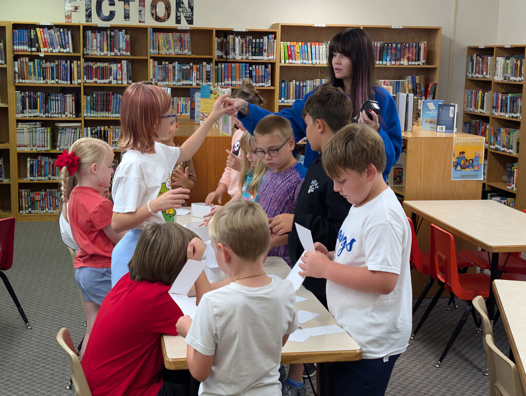 Students working on STEM activity in library