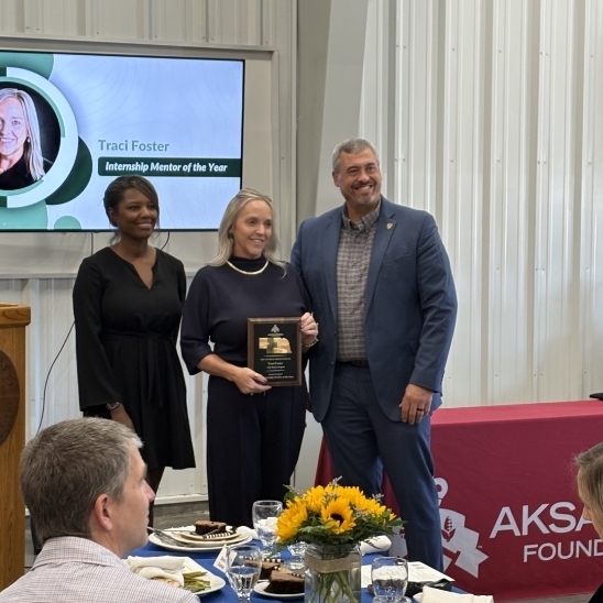photo of Mr. Foster receiving her award