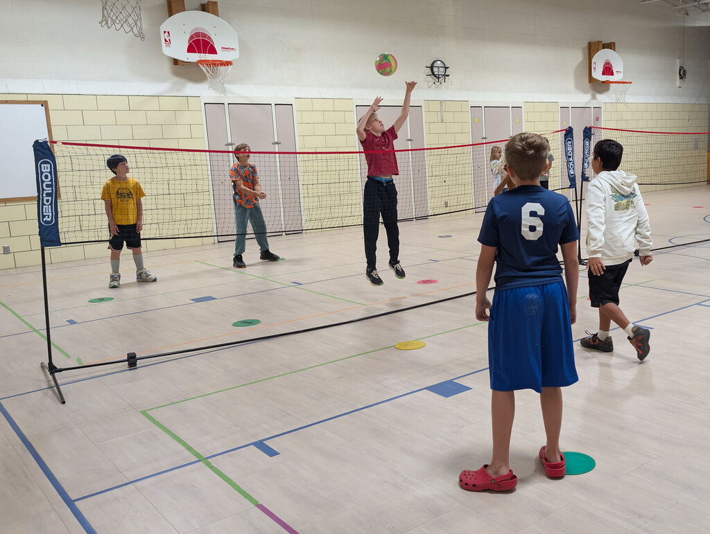 Students in PE playing volleyball.
