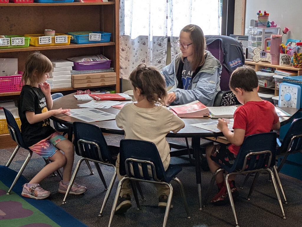 Students working with teacher.