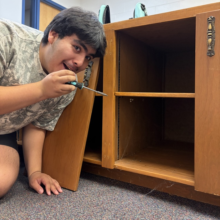 Student puts together a cabinet