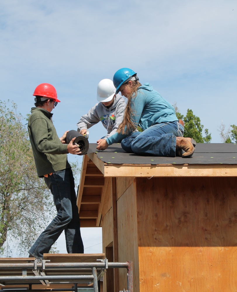 Students add roofing to building 